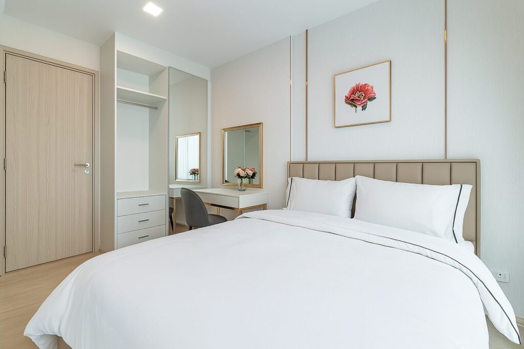 Modern bedroom with built-in wardrobe and study desk at Life One Wireless Bangkok